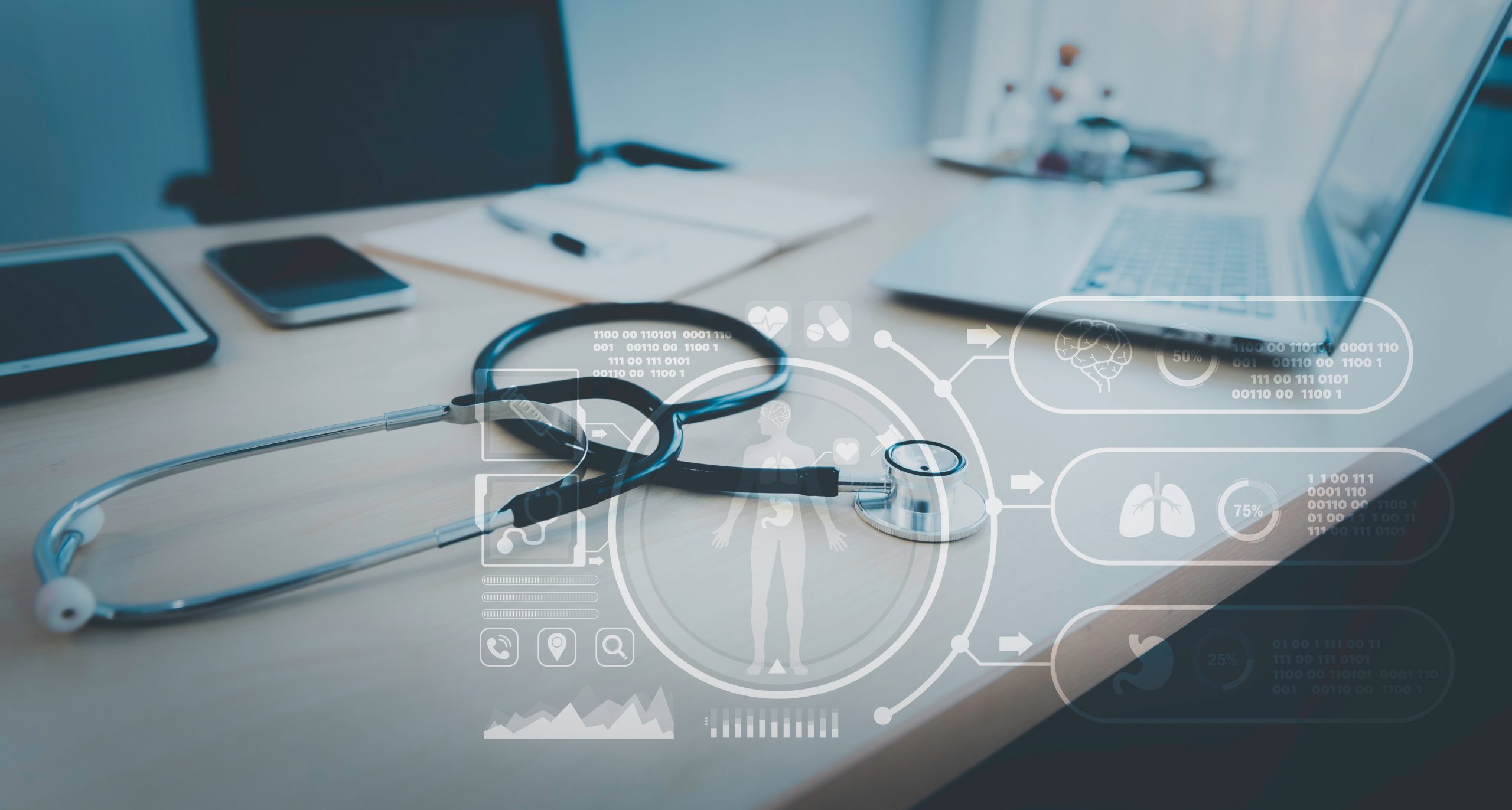 A stethoscope resting on a desk next to a laptop and a smartphone; an illustration of modern healthcare technology.