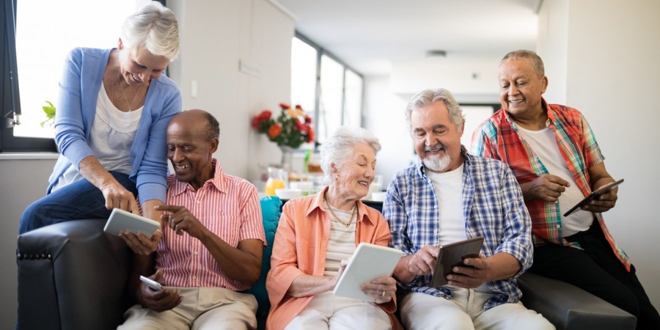Older adults engaging with tablets, showcasing the need for digital proficiency.