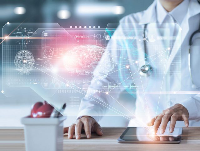 A doctor using a tablet with a digital interface to access medical records.