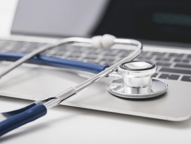 A stethoscope placed on a laptop, indicating expertise in the healthcare domain.