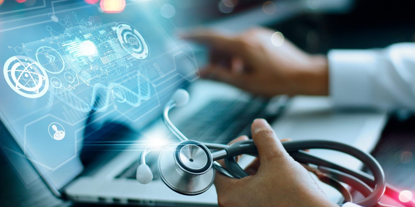 Product development life cycle – doctor using a laptop, stethoscope in hand