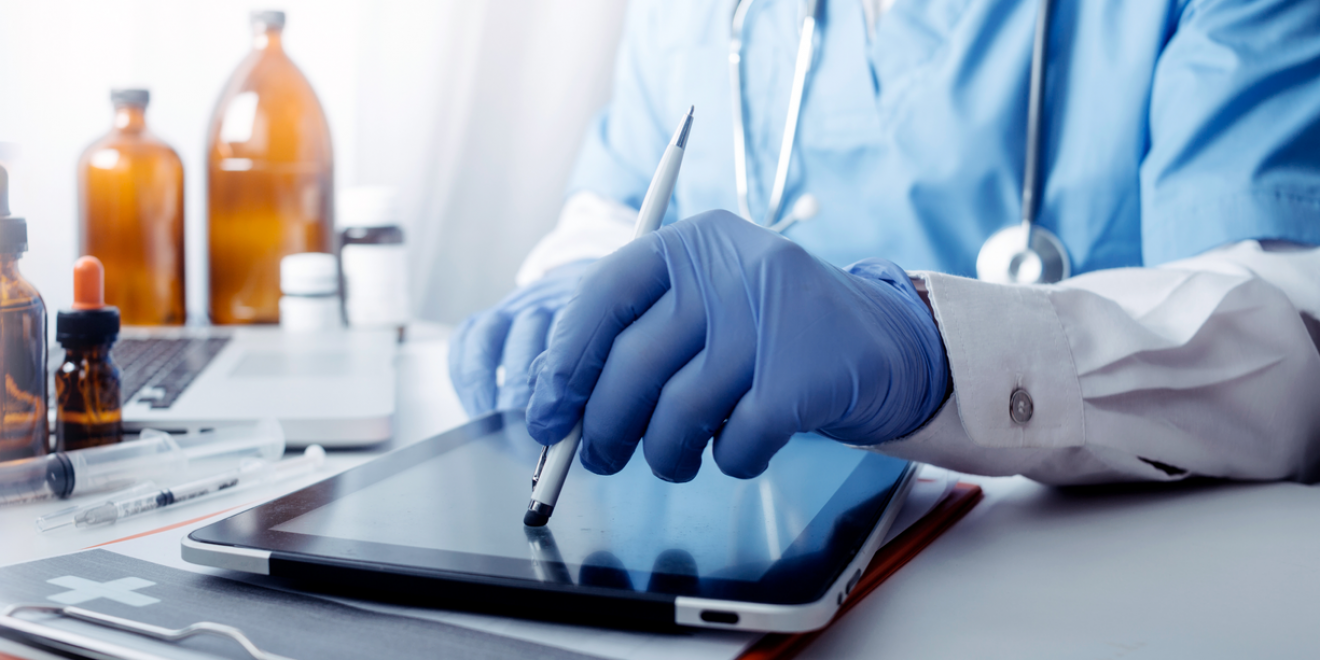 A doctor using a tablet. Visualisation of standards in healthcare software development.